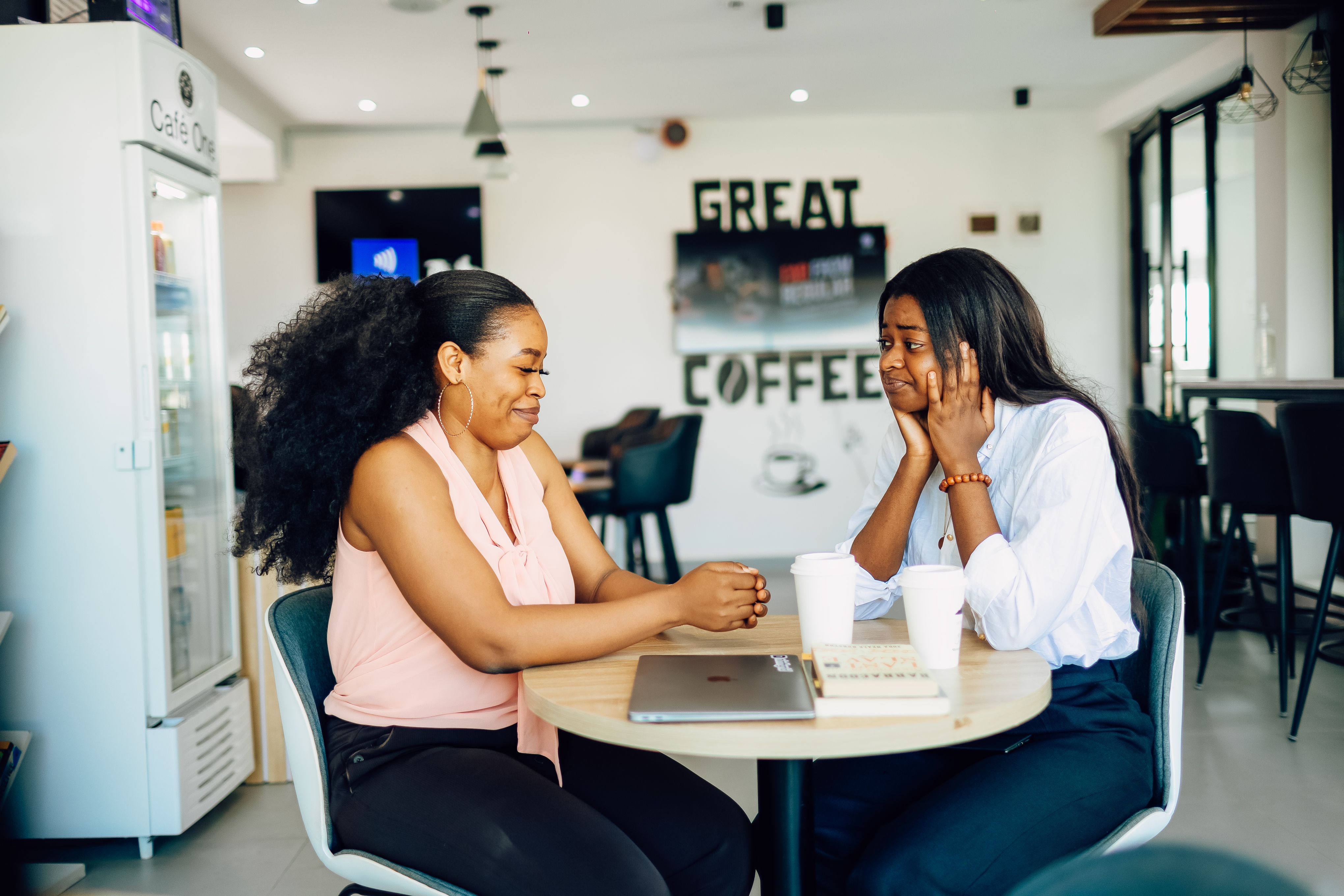 Two friends talking over coffee