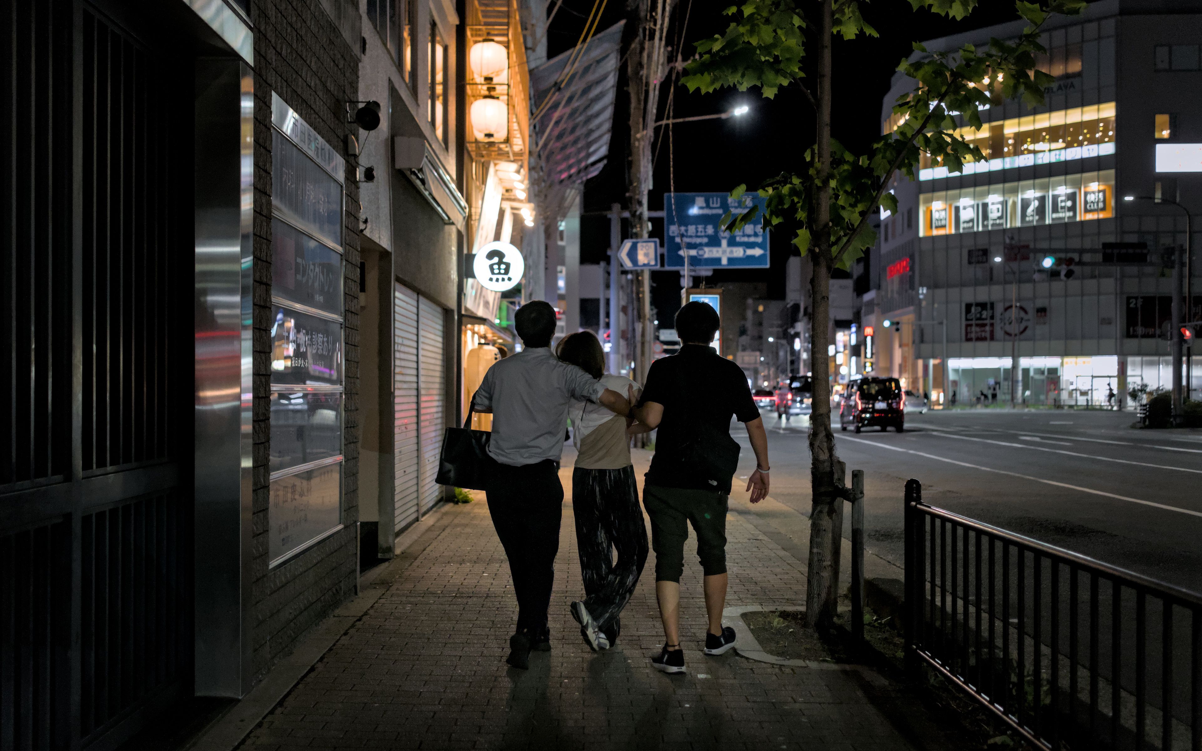 Friends walking together during a city night out