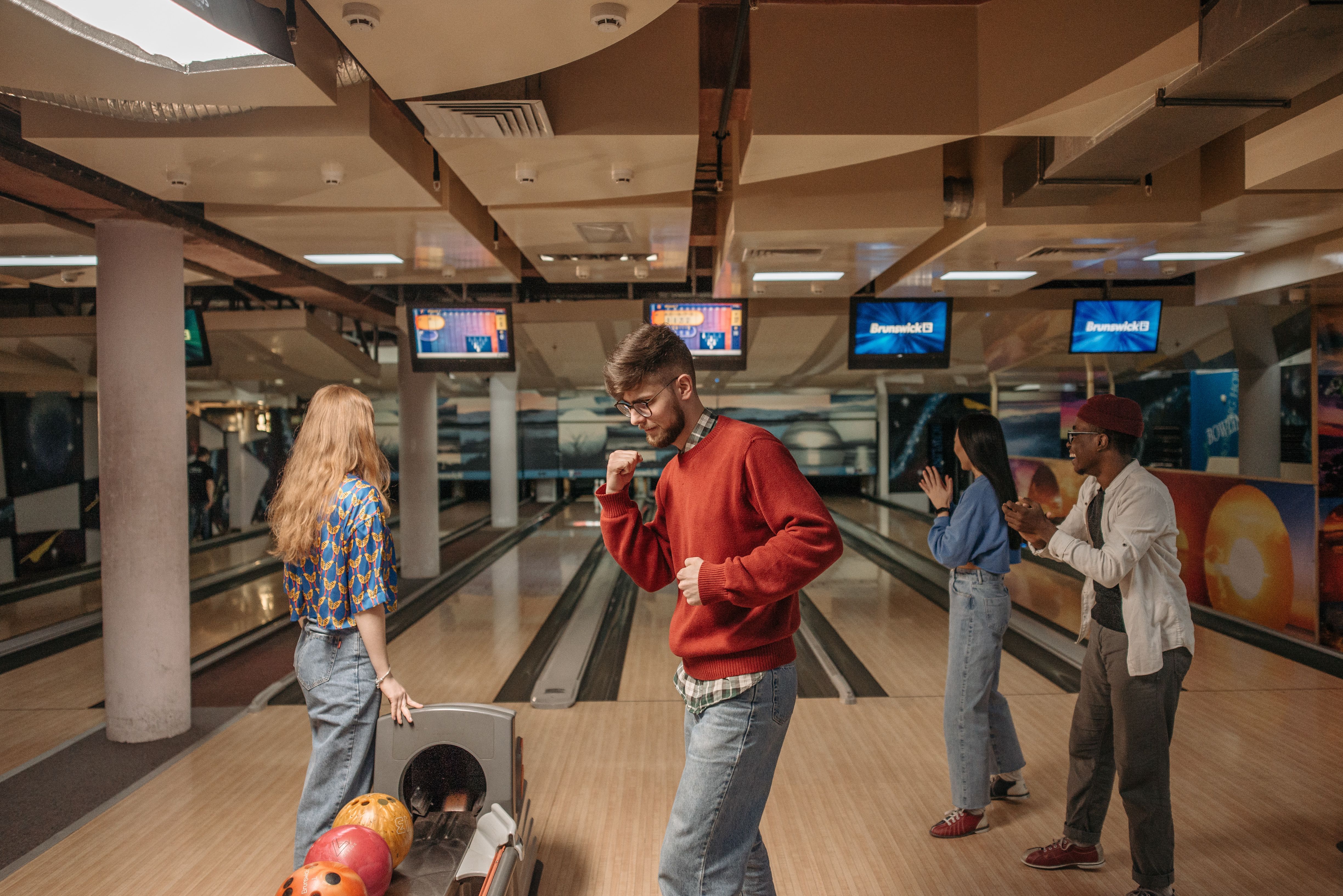 Friends laughing together during a bowling night
